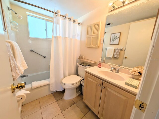 full bathroom featuring tile patterned flooring, toilet, vanity, and shower / bathtub combination with curtain