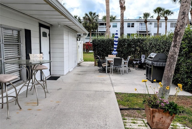 view of patio / terrace with outdoor dining space and a grill