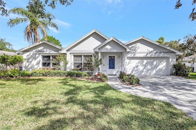 ranch-style home featuring an attached garage, driveway, a front lawn, and stucco siding