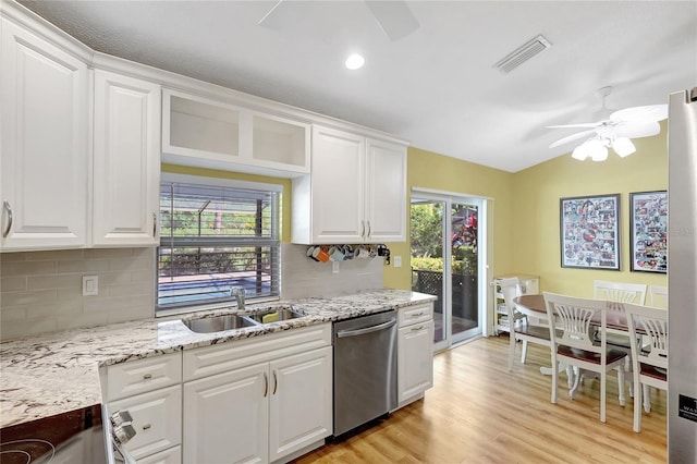 kitchen featuring white cabinets, visible vents, a ceiling fan, stainless steel dishwasher, and a sink