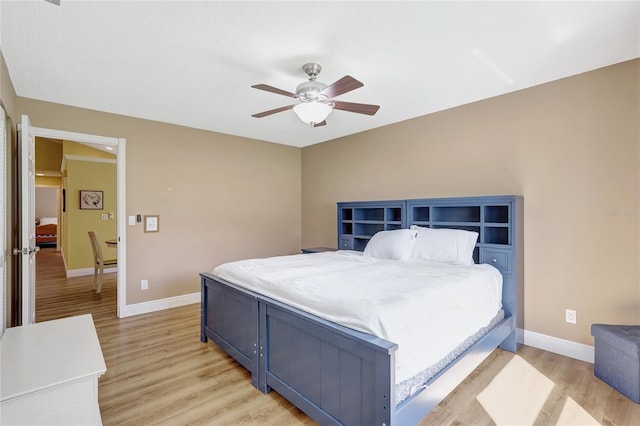 bedroom featuring ceiling fan, baseboards, and light wood-style flooring