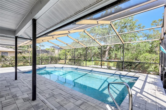 outdoor pool with glass enclosure and a patio