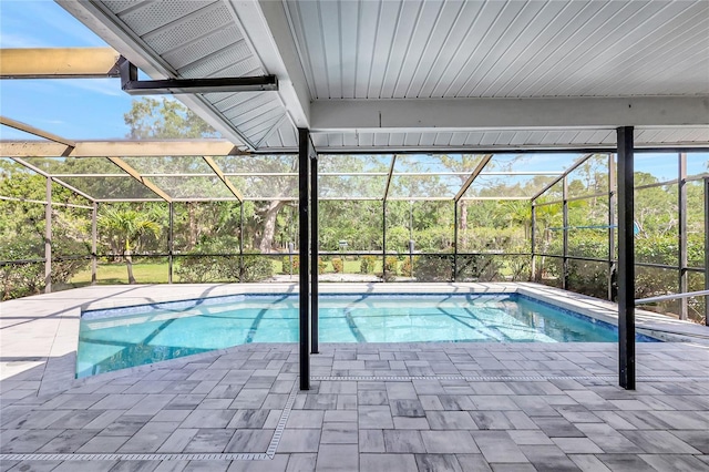outdoor pool featuring a patio area and glass enclosure