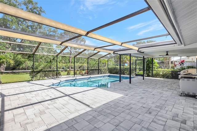 pool featuring glass enclosure and a patio