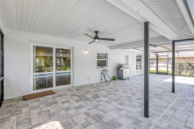 view of patio / terrace with grilling area, glass enclosure, and ceiling fan