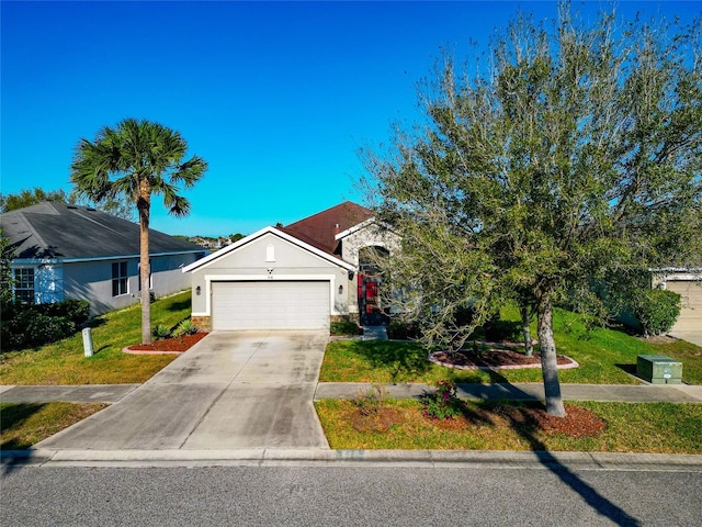 view of front facade featuring a front yard, concrete driveway, brick siding, and a garage