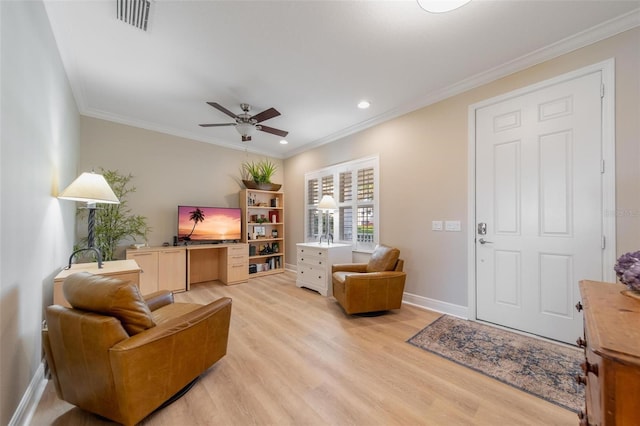 living area with a ceiling fan, visible vents, baseboards, light wood-style floors, and crown molding