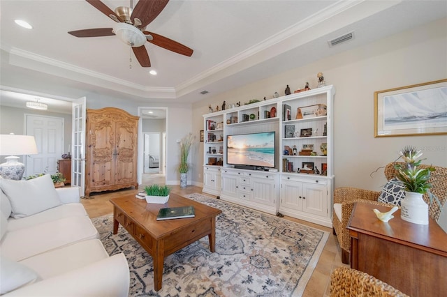 living room with recessed lighting, a tray ceiling, ceiling fan, and crown molding