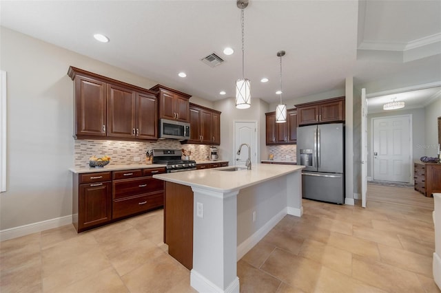 kitchen featuring visible vents, a kitchen island with sink, a sink, light countertops, and appliances with stainless steel finishes