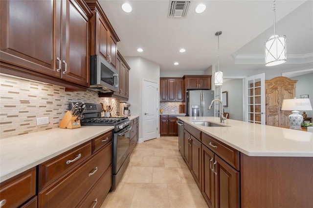 kitchen with a center island with sink, visible vents, a sink, appliances with stainless steel finishes, and a raised ceiling