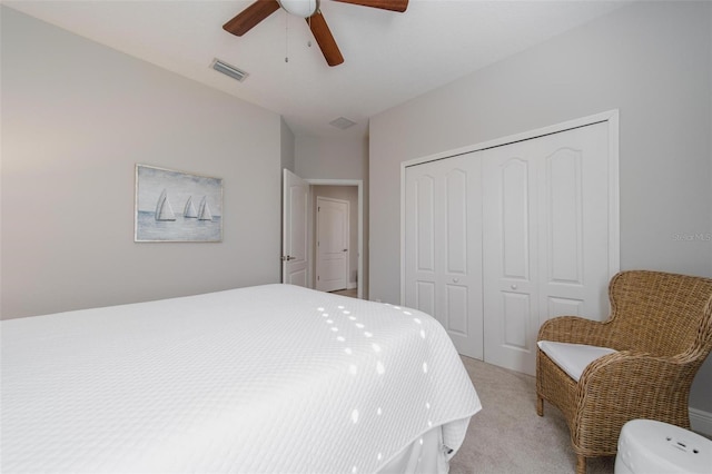 bedroom featuring visible vents, light colored carpet, a closet, and ceiling fan