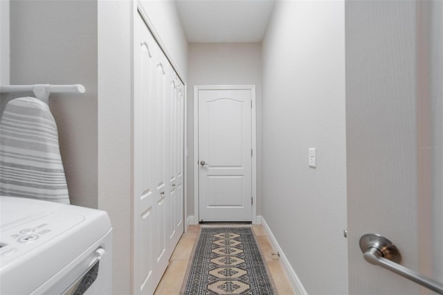 laundry room with laundry area, washer / clothes dryer, and baseboards