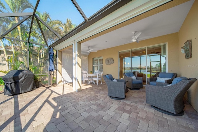 view of patio / terrace with outdoor lounge area, area for grilling, glass enclosure, and ceiling fan