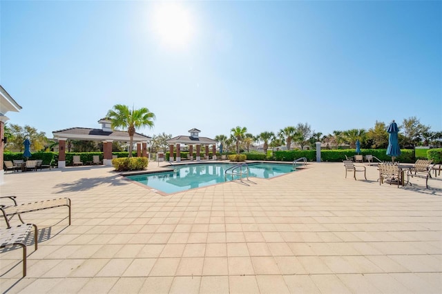 pool featuring a gazebo and a patio