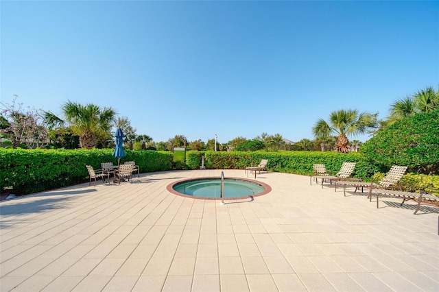 view of swimming pool with an in ground hot tub and a patio