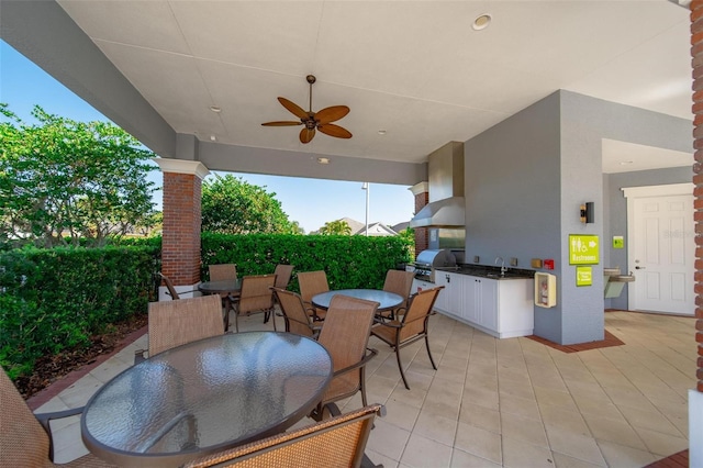 view of patio / terrace featuring outdoor dining area, area for grilling, and ceiling fan