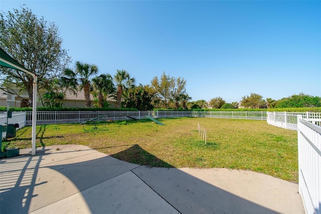 view of yard featuring a rural view, a patio, and a fenced backyard