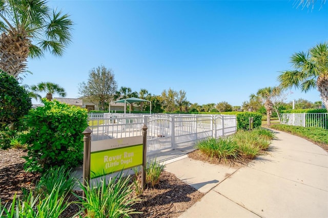 surrounding community featuring a gate and fence