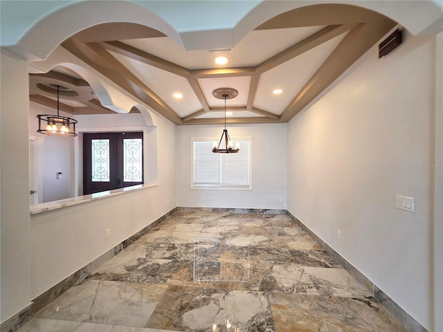 spare room with a chandelier, marble finish floor, coffered ceiling, and baseboards