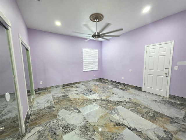 spare room featuring recessed lighting, baseboards, marble finish floor, and a ceiling fan