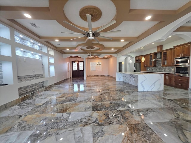 kitchen with visible vents, a ceiling fan, coffered ceiling, refrigerator, and arched walkways