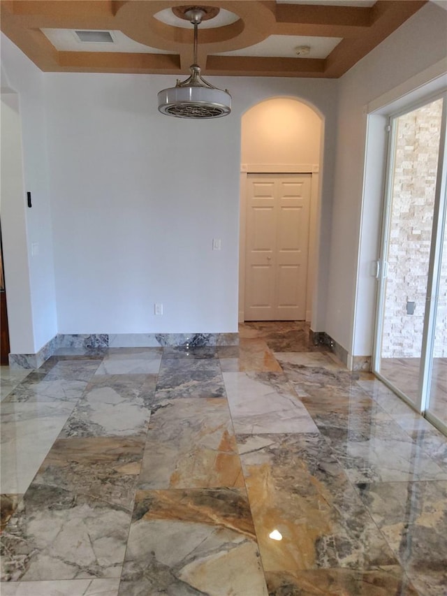 spare room featuring visible vents, baseboards, arched walkways, marble finish floor, and coffered ceiling