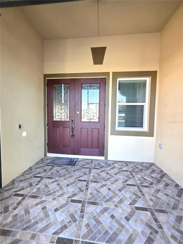 view of exterior entry featuring stucco siding