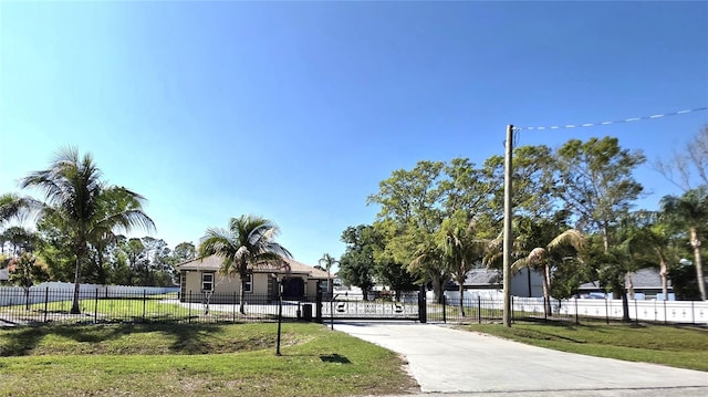 view of community with a yard and a fenced front yard