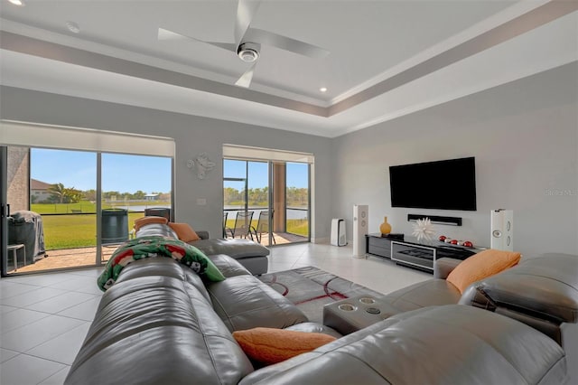 living area with ornamental molding, recessed lighting, light tile patterned floors, a raised ceiling, and ceiling fan