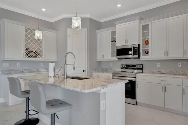 kitchen featuring glass insert cabinets, appliances with stainless steel finishes, light tile patterned flooring, white cabinetry, and a sink