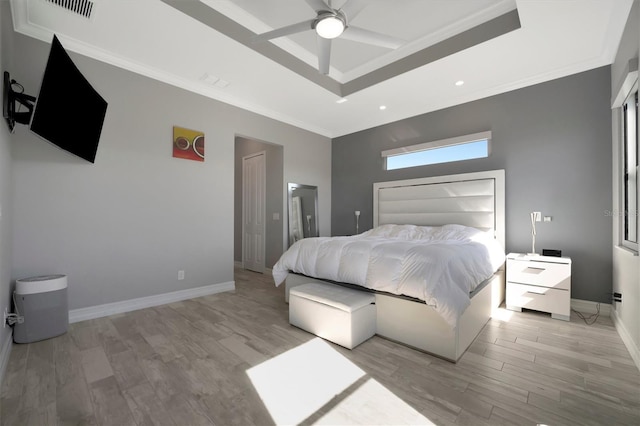 bedroom featuring baseboards, recessed lighting, crown molding, light wood-style floors, and a raised ceiling