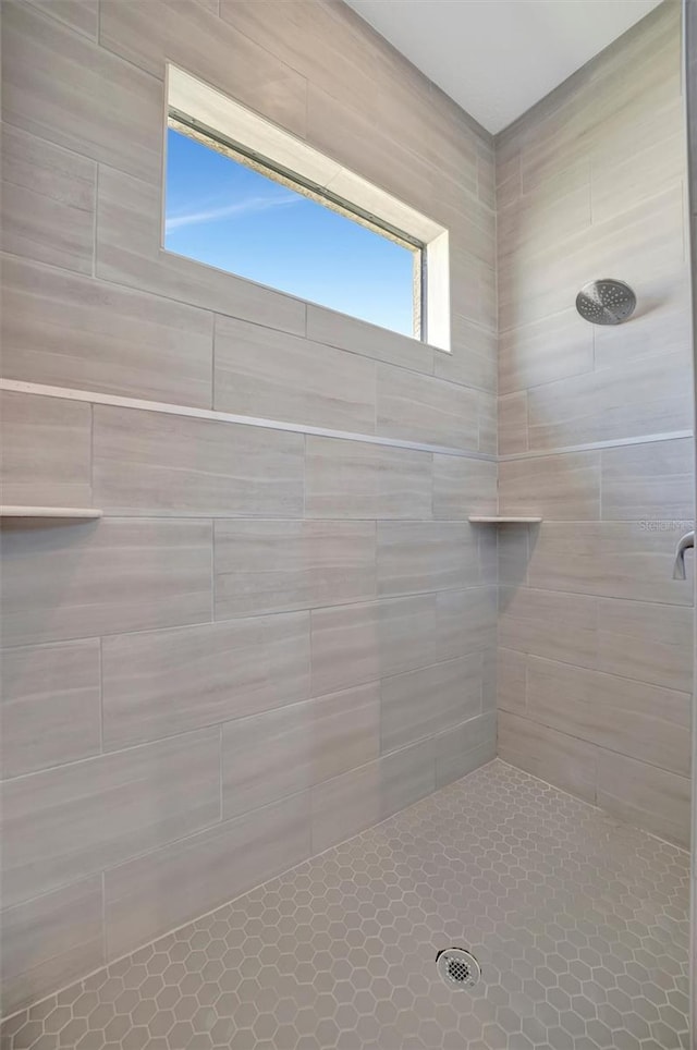 full bath with a tile shower