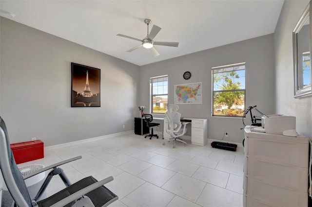 home office with light tile patterned floors, baseboards, and ceiling fan