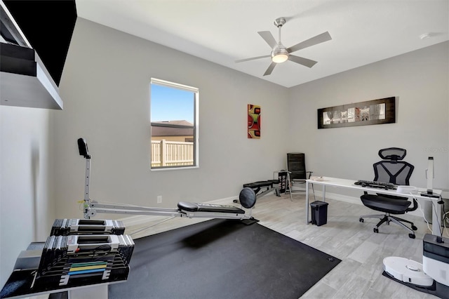 exercise room with wood finished floors and a ceiling fan