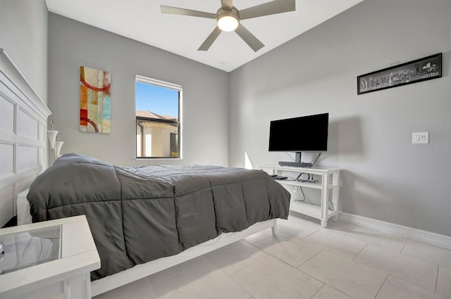 tiled bedroom with ceiling fan and baseboards