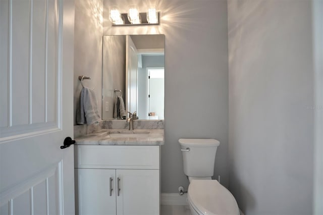 half bathroom with toilet and vanity