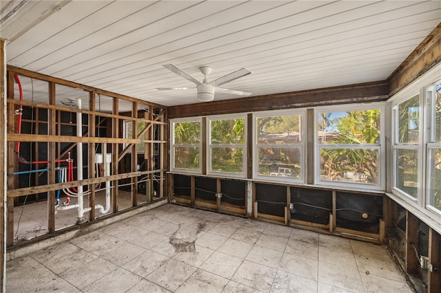 unfurnished sunroom featuring a wealth of natural light and a ceiling fan