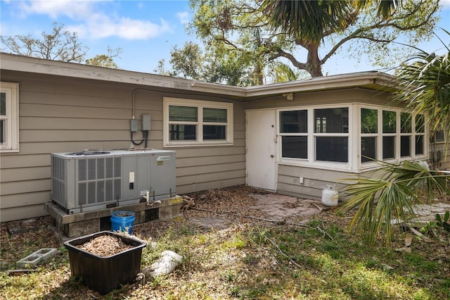 rear view of house featuring central AC unit