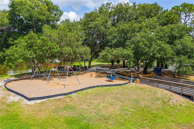 communal playground with a water view and a lawn