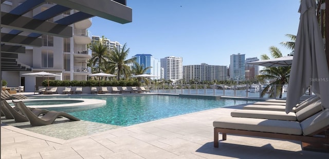 community pool with a city view, a hot tub, and a patio