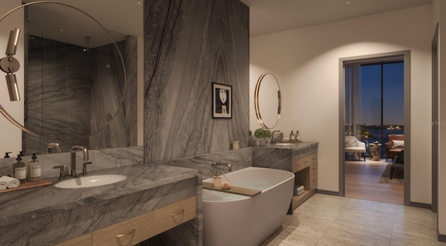 bathroom with vanity, a freestanding tub, and a walk in shower