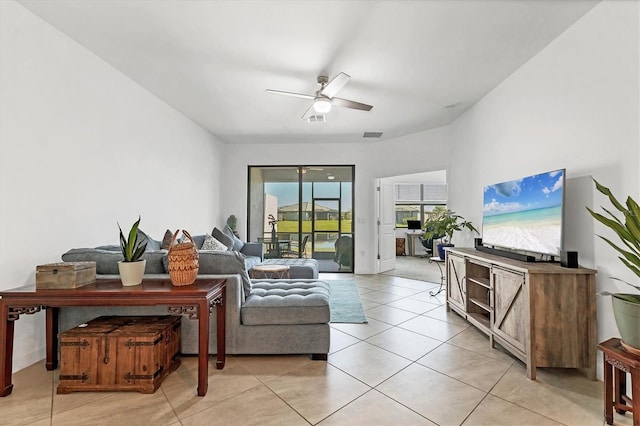 living area with light tile patterned floors, visible vents, and ceiling fan