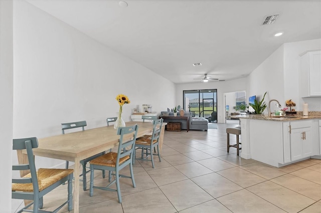 dining area featuring ceiling fan, visible vents, and light tile patterned flooring
