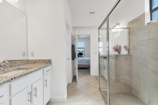 bathroom featuring tile patterned flooring, visible vents, connected bathroom, a shower stall, and vanity