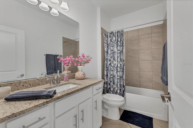 bathroom featuring tile patterned floors, toilet, vanity, and shower / tub combo