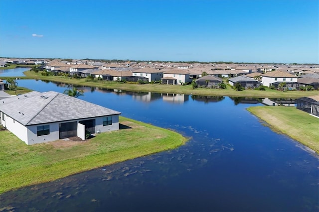 drone / aerial view with a residential view and a water view
