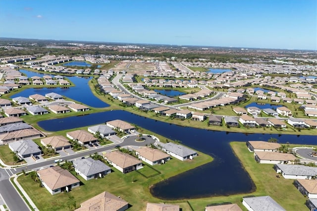 drone / aerial view featuring a residential view and a water view