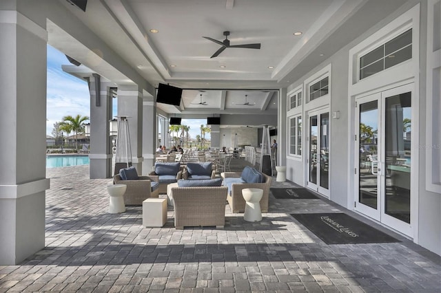 view of patio with an outdoor pool, french doors, an outdoor hangout area, and a ceiling fan