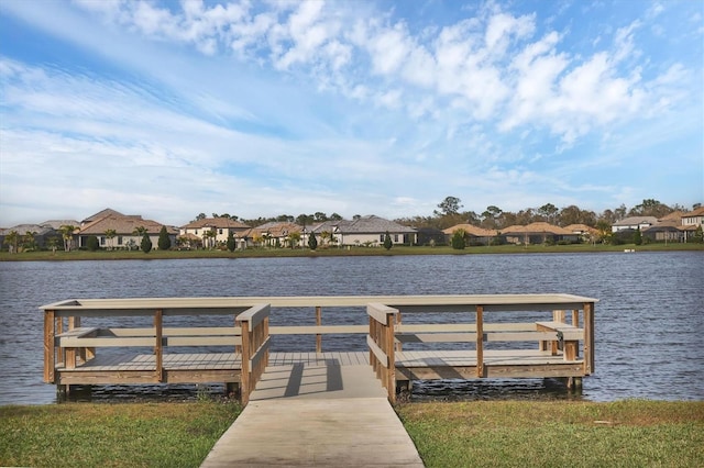 dock area with a residential view and a water view