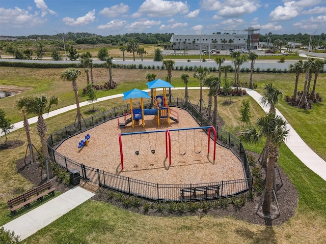 community jungle gym featuring a yard, central AC unit, and fence